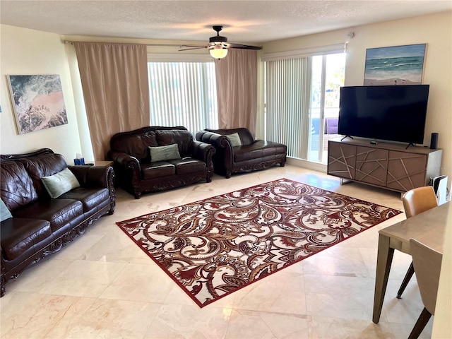 1180 Gulf Blvd Unit 306, Clearwater, FL 33767 - living room featuring ceiling fan and a textured ceiling