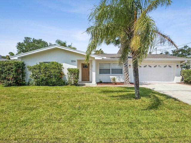 2016 Cove Dr, Largo, FL 33774 - ranch-style house featuring stucco siding, an attached garage, driveway, and a front lawn