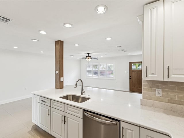 2016 Cove Dr, Largo, FL 33774 - kitchen with stainless steel dishwasher, a sink, ceiling fan, white cabinets, and recessed lighting