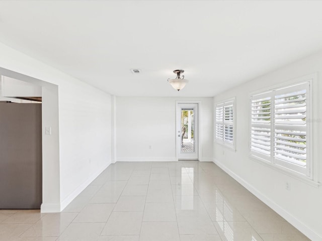 2016 Cove Dr, Largo, FL 33774 - unfurnished room featuring plenty of natural light, light tile patterned flooring, and baseboards