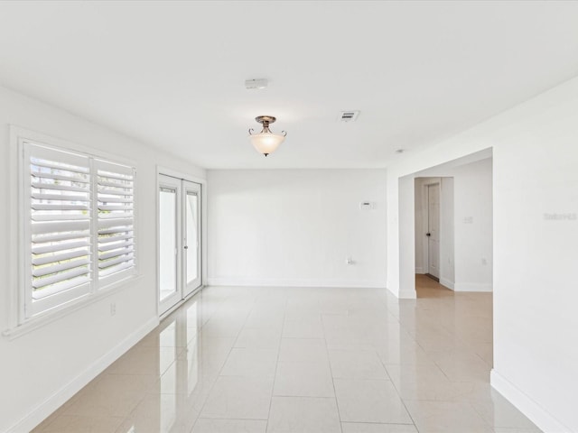 2016 Cove Dr, Largo, FL 33774 - spare room with baseboards and light tile patterned floors