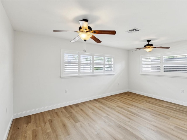 2016 Cove Dr, Largo, FL 33774 - empty room with a ceiling fan, light wood-style flooring, and baseboards