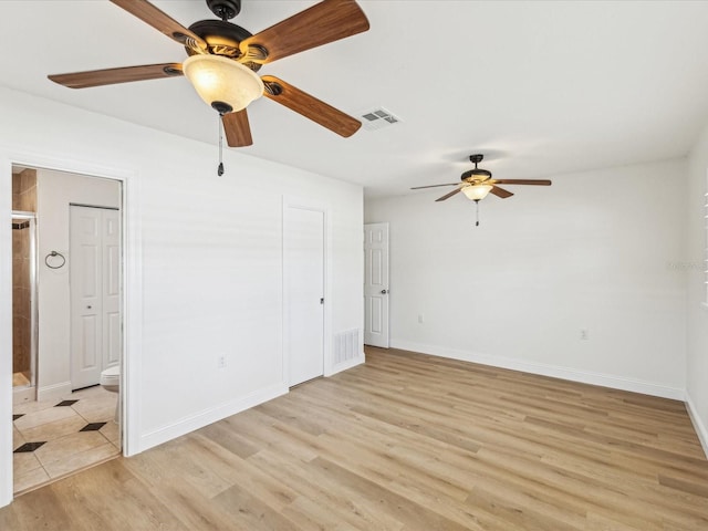 2016 Cove Dr, Largo, FL 33774 - unfurnished room with a ceiling fan, light wood finished floors, and baseboards