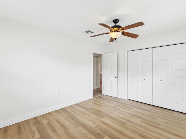 2016 Cove Dr, Largo, FL 33774 - unfurnished bedroom with light wood-type flooring, baseboards, a closet, and a ceiling fan