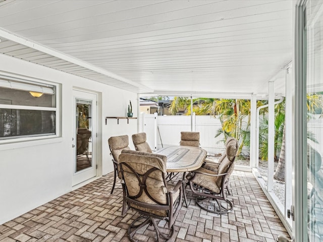 2016 Cove Dr, Largo, FL 33774 - sunroom featuring brick flooring and outdoor dining area