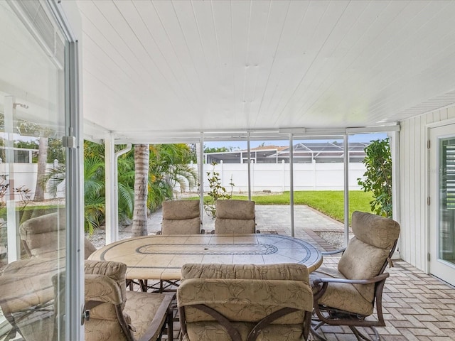 2016 Cove Dr, Largo, FL 33774 - sunroom featuring brick floors, outdoor dining space, plenty of natural light, and wood ceiling
