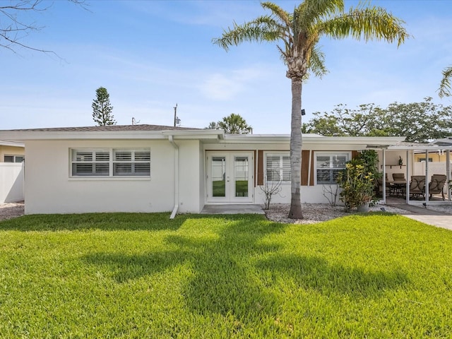 2016 Cove Dr, Largo, FL 33774 - back of property featuring french doors, stucco siding, a yard, and a patio area