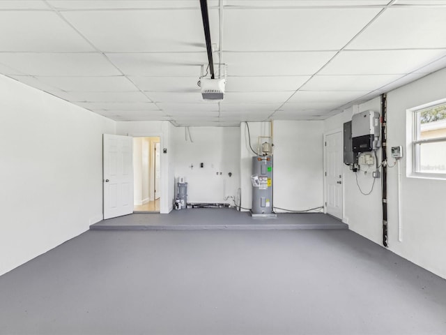 2016 Cove Dr, Largo, FL 33774 - garage featuring electric water heater, electric panel, and a garage door opener