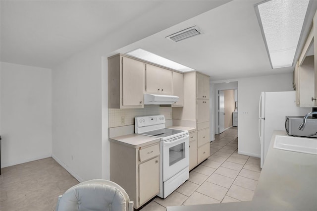 1598 Brookside Blvd, Largo, FL 33770 - kitchen featuring white electric range, under cabinet range hood, light countertops, backsplash, and light tile patterned floors