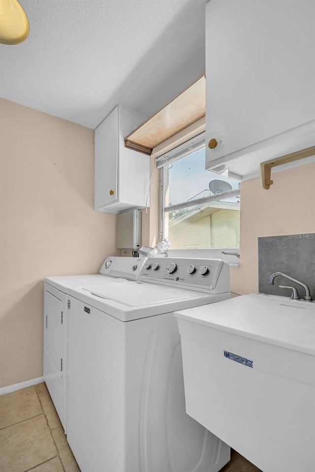 1598 Brookside Blvd, Largo, FL 33770 - laundry room with washer and clothes dryer, cabinet space, baseboards, and light tile patterned floors