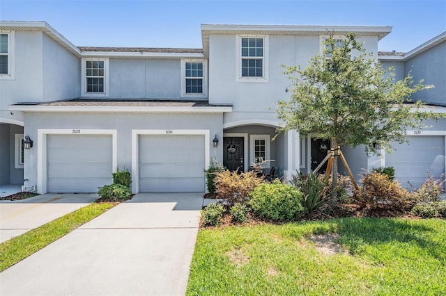7030 Summer Holly Pl, Riverview, FL 33578 - view of front facade featuring driveway, an attached garage, and stucco siding