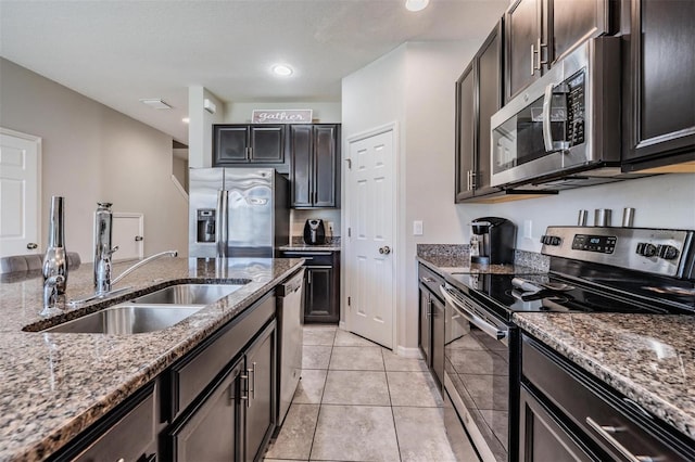 7030 Summer Holly Pl, Riverview, FL 33578 - kitchen with appliances with stainless steel finishes, a sink, stone counters, light tile patterned floors, and recessed lighting