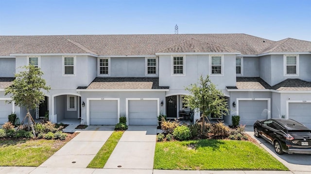 7030 Summer Holly Pl, Riverview, FL 33578 - multi unit property featuring roof with shingles, an attached garage, stucco siding, and driveway