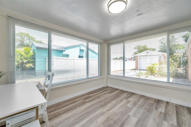 1117 Tyrone Blvd N, Saint Petersburg, FL 33710 - unfurnished sunroom featuring wood finished floors and baseboards
