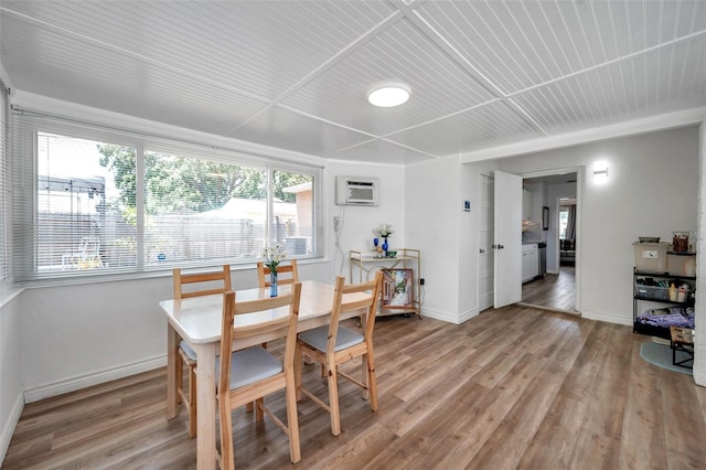 1117 Tyrone Blvd N, Saint Petersburg, FL 33710 - dining area with baseboards, light wood-type flooring, a wall mounted air conditioner, and wood ceiling