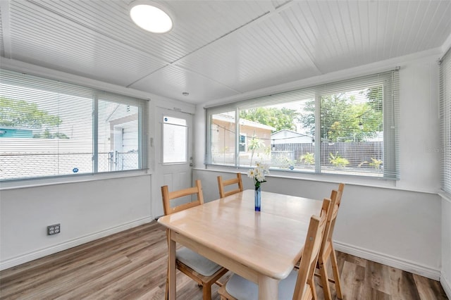 1117 Tyrone Blvd N, Saint Petersburg, FL 33710 - dining space featuring wood finished floors, plenty of natural light, baseboards, and wooden ceiling