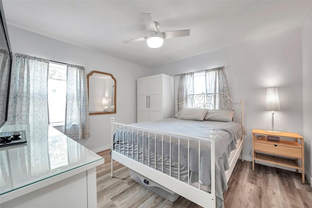 1117 Tyrone Blvd N, Saint Petersburg, FL 33710 - bedroom with light wood finished floors, baseboards, and ceiling fan