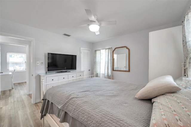 1117 Tyrone Blvd N, Saint Petersburg, FL 33710 - bedroom featuring light wood-style flooring, a ceiling fan, and baseboards