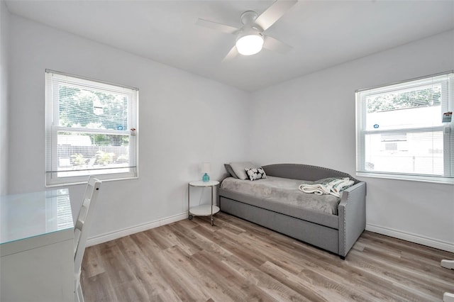 1117 Tyrone Blvd N, Saint Petersburg, FL 33710 - bedroom featuring multiple windows, light wood finished floors, baseboards, and ceiling fan