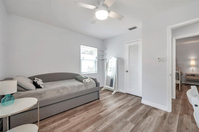 1117 Tyrone Blvd N, Saint Petersburg, FL 33710 - bedroom featuring light wood-style flooring, baseboards, ceiling fan, and a closet