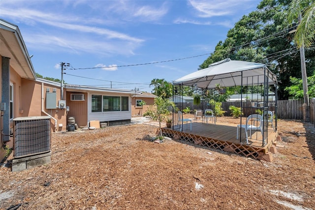 1117 Tyrone Blvd N, Saint Petersburg, FL 33710 - fenced backyard featuring a gazebo, a deck, and central air condition unit