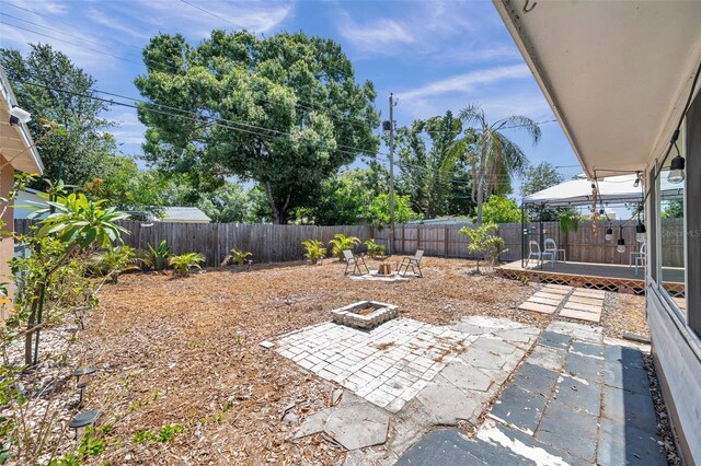1117 Tyrone Blvd N, Saint Petersburg, FL 33710 - fenced backyard with an outdoor fire pit and a patio area