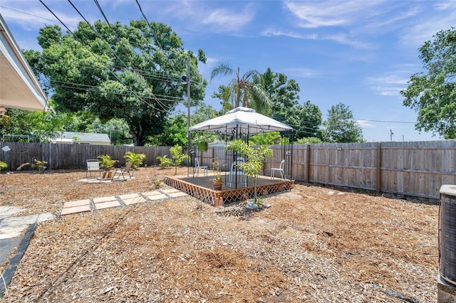 1117 Tyrone Blvd N, Saint Petersburg, FL 33710 - fenced backyard with a gazebo, a deck, and central AC