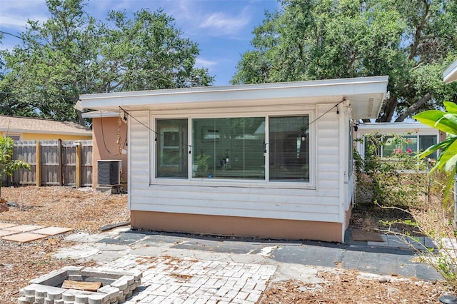 1117 Tyrone Blvd N, Saint Petersburg, FL 33710 - view of side of home featuring a patio area and central AC