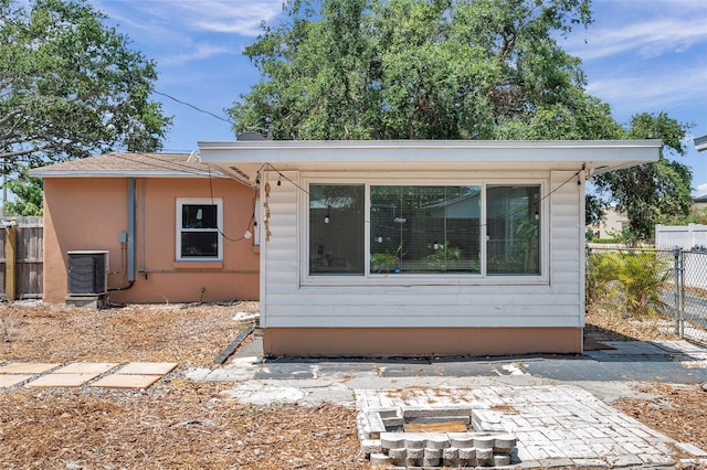 1117 Tyrone Blvd N, Saint Petersburg, FL 33710 - rear view of house featuring an outdoor fire pit, central air condition unit, and a patio area