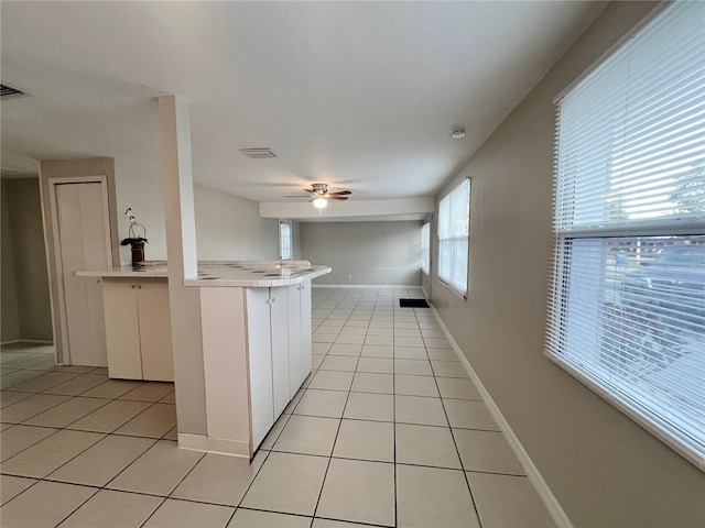 10367 109th Ave, Largo, FL 33773 - kitchen with light tile patterned floors, a ceiling fan, tile countertops, and baseboards