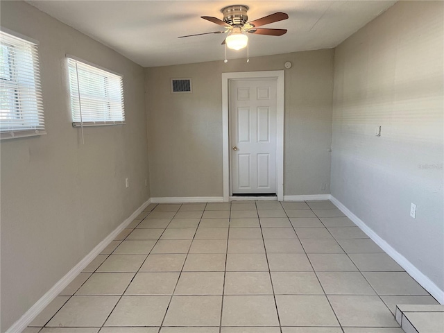 10367 109th Ave, Largo, FL 33773 - spare room featuring a ceiling fan, light tile patterned floors, and baseboards