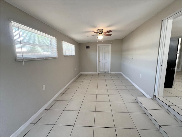 10367 109th Ave, Largo, FL 33773 - empty room featuring a ceiling fan, light tile patterned floors, and baseboards
