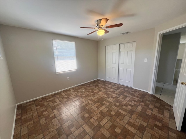 10367 109th Ave, Largo, FL 33773 - unfurnished bedroom with a closet, brick patterned floors, baseboards, and ceiling fan