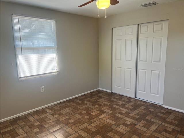 10367 109th Ave, Largo, FL 33773 - unfurnished bedroom featuring brick patterned floors, baseboards, a closet, and ceiling fan