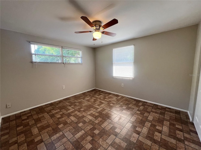 10367 109th Ave, Largo, FL 33773 - spare room featuring baseboards, ceiling fan, and brick patterned floors