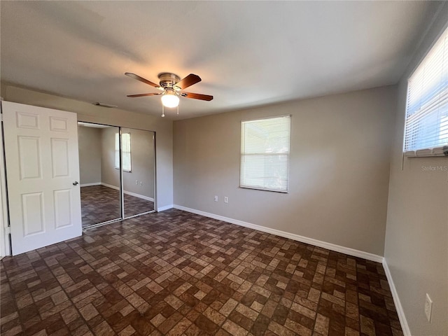 10367 109th Ave, Largo, FL 33773 - unfurnished bedroom featuring baseboards, a closet, and brick patterned floors