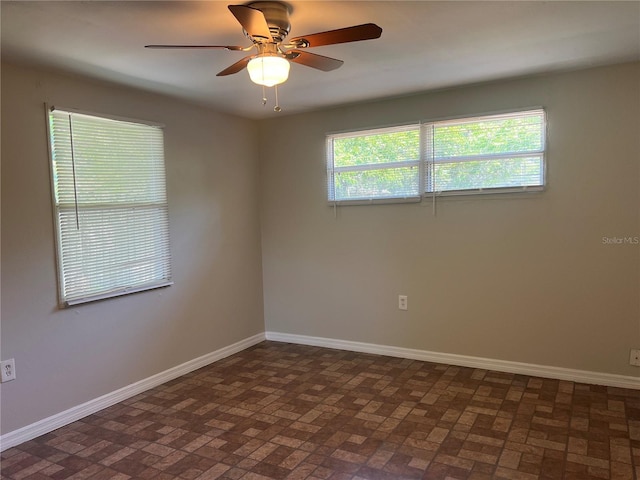 10367 109th Ave, Largo, FL 33773 - empty room with brick patterned floors, baseboards, and ceiling fan