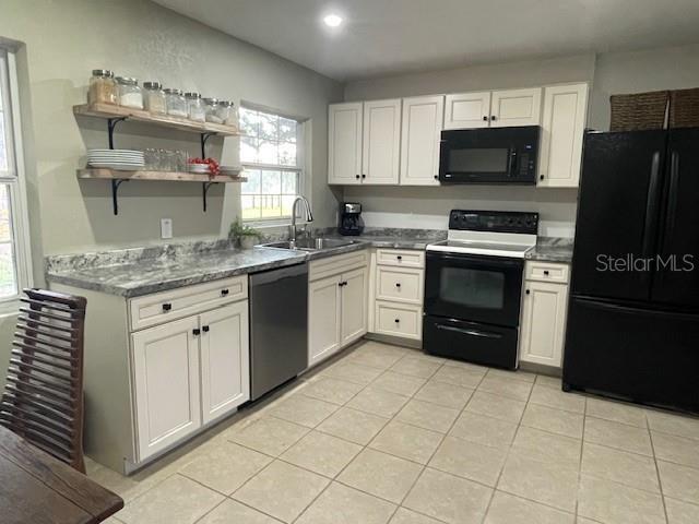 2748 Crk 543, Sumterville, FL 33585 - kitchen featuring black appliances, a sink, open shelves, white cabinetry, and recessed lighting