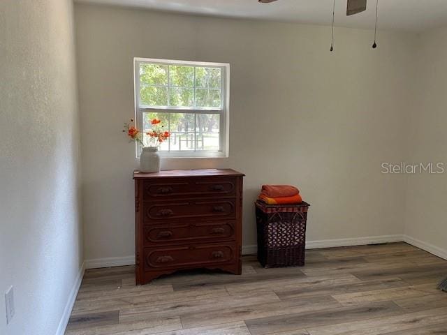 2748 Crk 543, Sumterville, FL 33585 - empty room featuring a ceiling fan, wood finished floors, and baseboards
