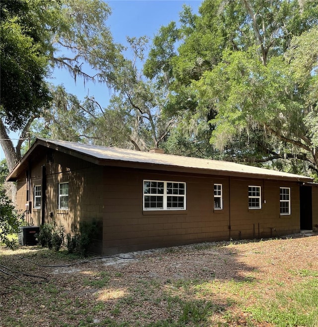 2748 Crk 543, Sumterville, FL 33585 - view of property exterior featuring central AC unit and concrete block siding