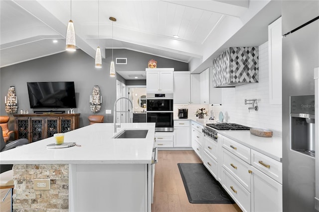 4649 Neptune Dr SE, Saint Petersburg, FL 33705 - kitchen featuring a sink, appliances with stainless steel finishes, open floor plan, light wood-type flooring, and tasteful backsplash