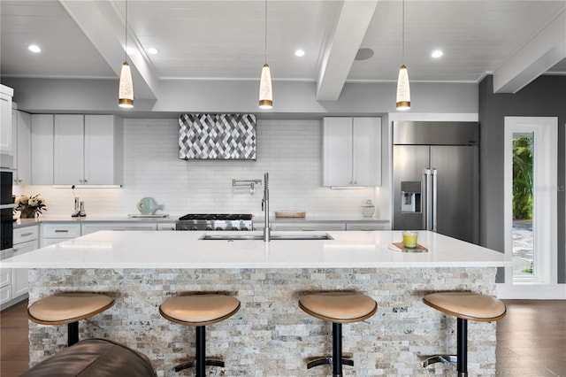 4649 Neptune Dr SE, Saint Petersburg, FL 33705 - kitchen featuring stainless steel fridge with ice dispenser, a sink, dark wood-style flooring, beam ceiling, and decorative backsplash