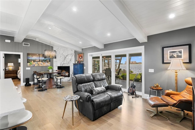 4649 Neptune Dr SE, Saint Petersburg, FL 33705 - living area with light wood-type flooring, a fireplace, baseboards, a water view, and recessed lighting