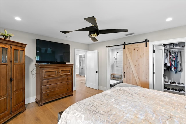 4649 Neptune Dr SE, Saint Petersburg, FL 33705 - bedroom featuring a barn door, baseboards, light wood-type flooring, recessed lighting, and a closet