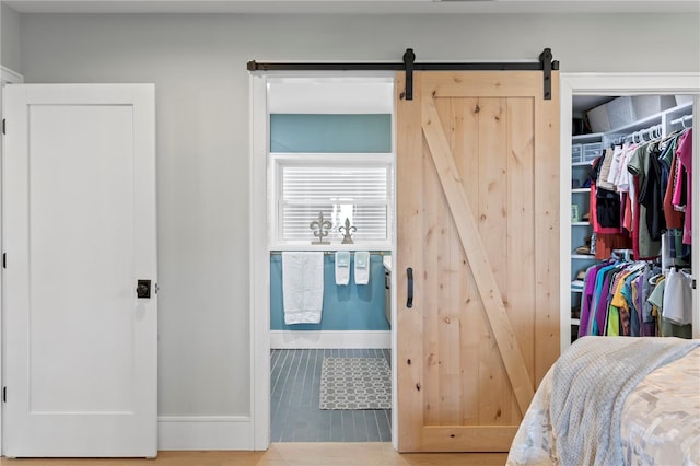 4649 Neptune Dr SE, Saint Petersburg, FL 33705 - bedroom with a barn door, baseboards, and a closet