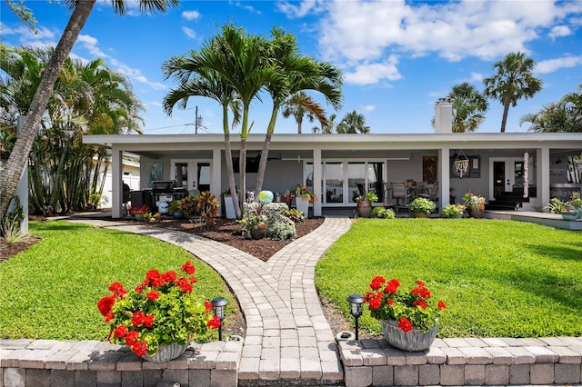4649 Neptune Dr SE, Saint Petersburg, FL 33705 - back of house with french doors, a yard, and stucco siding