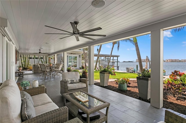 4649 Neptune Dr SE, Saint Petersburg, FL 33705 - sunroom featuring a water view, a ceiling fan, outdoor lounge area, and outdoor dining area