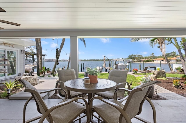 4649 Neptune Dr SE, Saint Petersburg, FL 33705 - view of patio / terrace featuring a dock, a water view, outdoor dining space, and boat lift