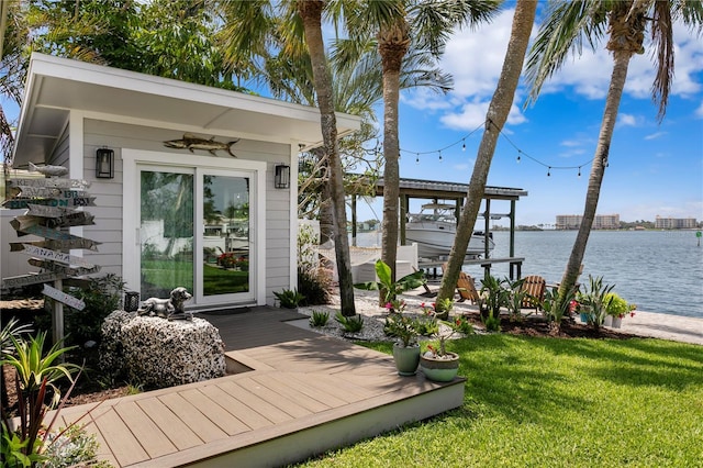 4649 Neptune Dr SE, Saint Petersburg, FL 33705 - wooden deck with a lawn, a water view, boat lift, and a boat dock