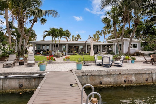 4649 Neptune Dr SE, Saint Petersburg, FL 33705 - dock featuring a patio, a lawn, and a water view